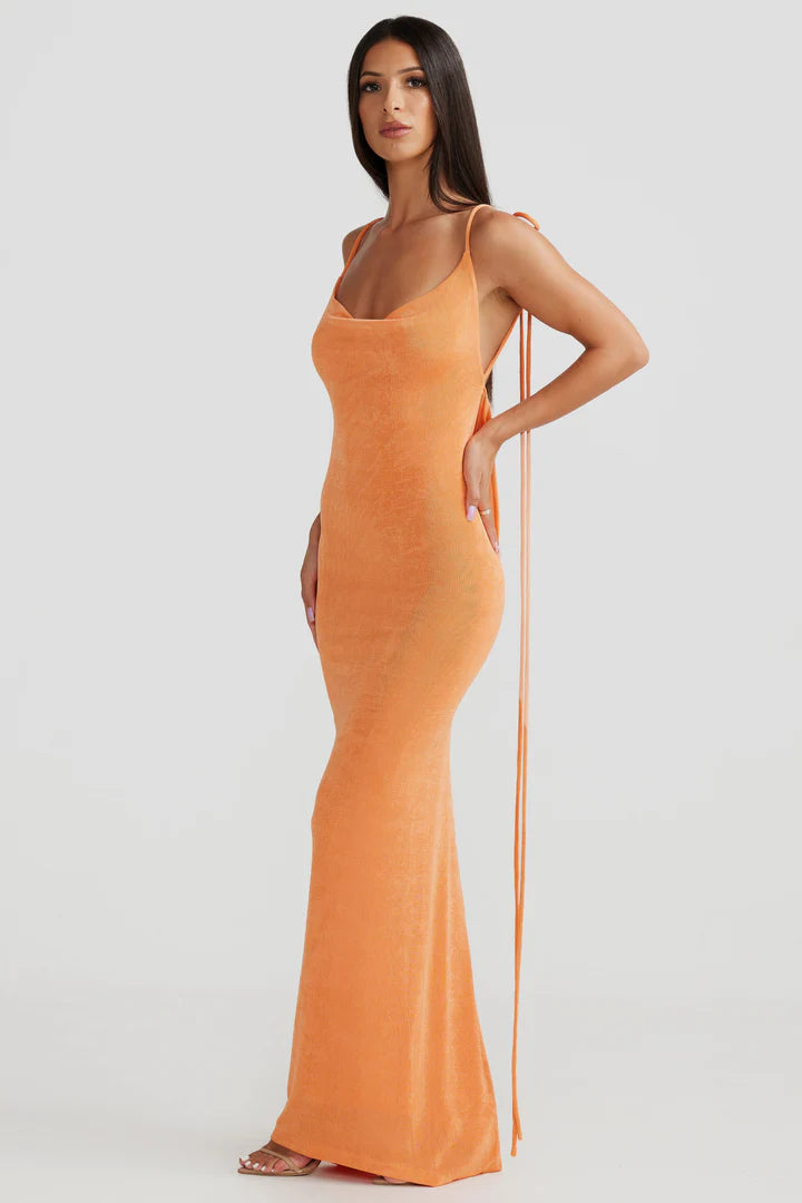 Woman wearing peach ribbed sleeveless maxi gown with cowl neckline — Melani The Label | Endless UAE