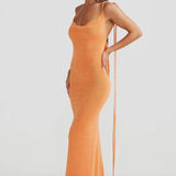 Woman wearing peach ribbed sleeveless maxi gown with cowl neckline — Melani The Label | Endless UAE