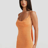 Woman wearing peach ribbed sleeveless maxi gown with cowl neckline — Melani The Label | Endless UAE