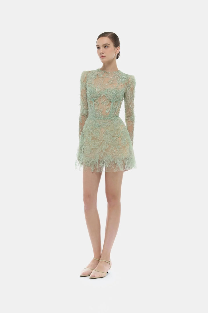 Elegant mint green beaded lace mini dress with long sleeves and sheer detailing on model — Montsand | Endless UAE