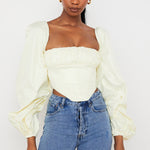 Miriam ivory cream balloon sleeve corset top with square neckline paired with blue denim jeans — House of CB | Endless UAE