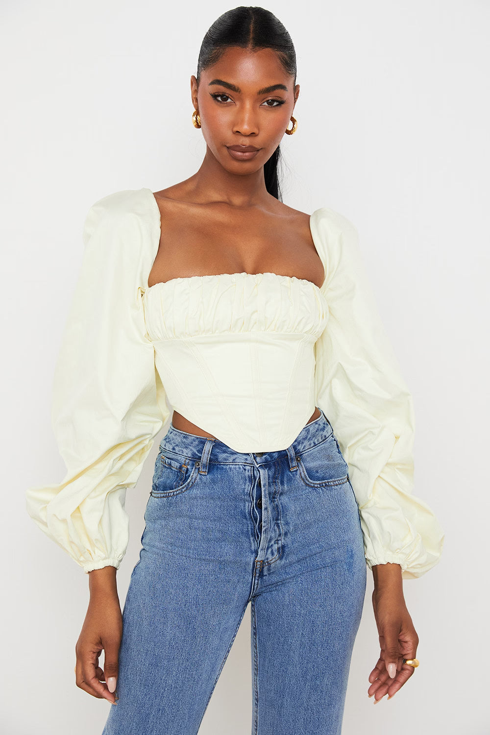 Miriam ivory cream balloon sleeve corset top with square neckline paired with blue denim jeans — House of CB | Endless UAE