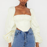 Miriam ivory cream balloon sleeve corset top with square neckline paired with blue denim jeans — House of CB | Endless UAE