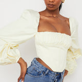 Elegant cream corset top with dramatic puffed balloon sleeves and straight neckline paired with denim jeans — House of CB | Endless UAE