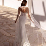 Elegant fitted wedding gown with sheer embellished cape and illusion back detail in ivory — You&I Bridal | Endless UAE
