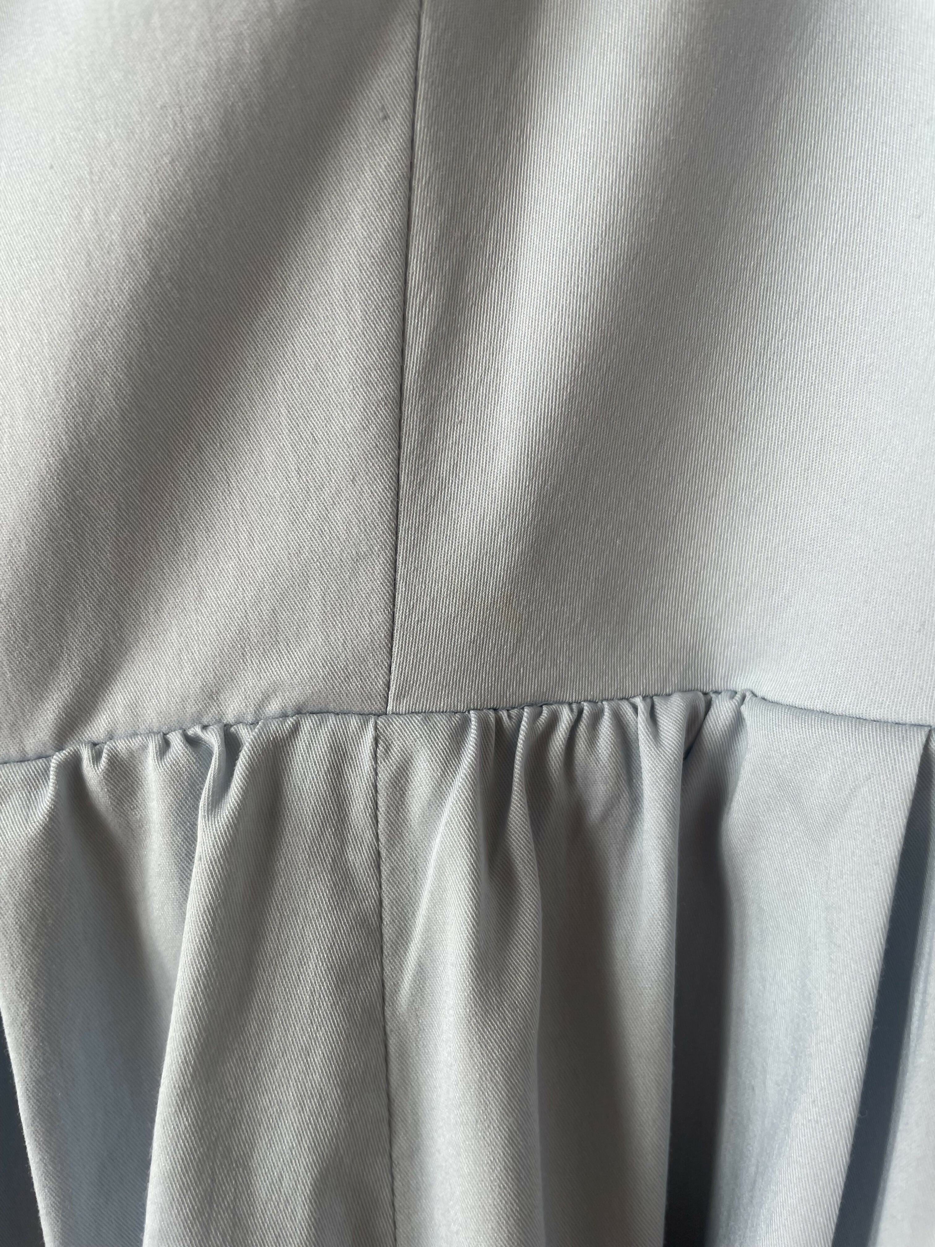 Woman wearing light blue sleeveless midi dress with corset top and full skirt — Endless | Endless UAE