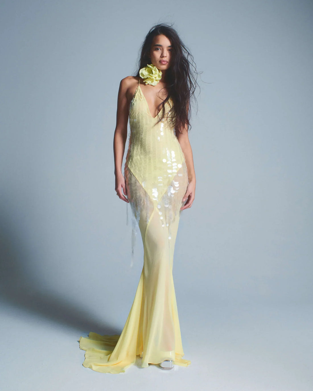 Woman wearing yellow sequined halter gown with flowing train and flower hair accessory — Rat & Boa | Endless UAE