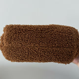 Gea Clutch in caramel brown textured fabric held in hand — TheMoire | Endless UAE