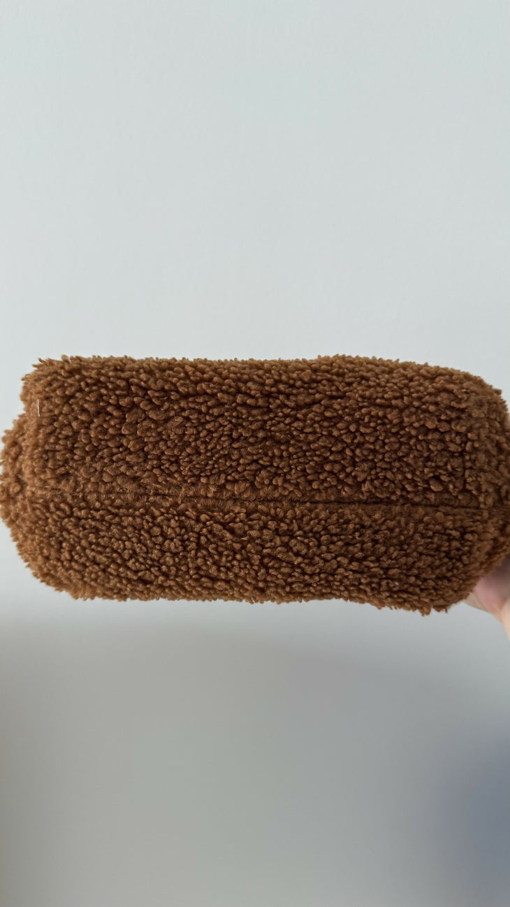 Gea Clutch in caramel brown textured fabric held in hand — TheMoire | Endless UAE