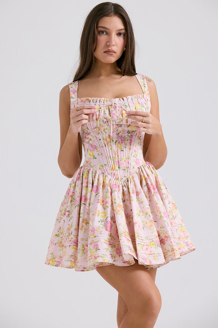 Pink floral print mini dress with gathered bodice, adjustable straps and full skirt modeled on brunette woman — House of CB | Endless UAE