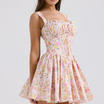 Pink floral print mini dress with shirred bodice and flared skirt modeled on brunette woman — House of CB | Endless UAE
