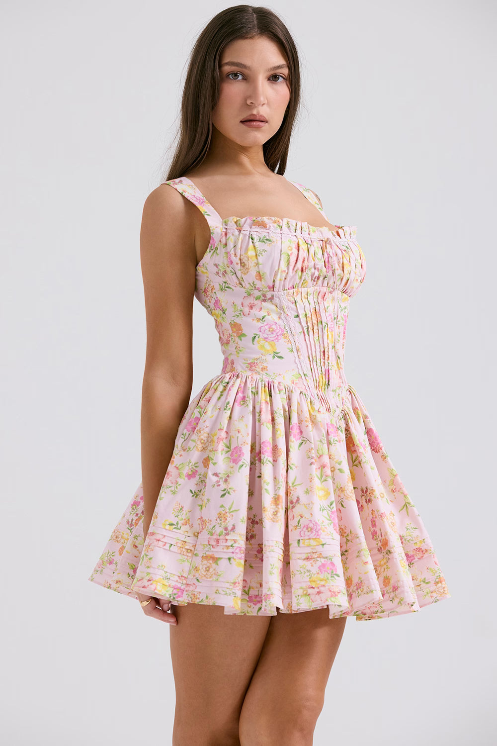 Pink floral print mini dress with shirred bodice and flared skirt modeled on brunette woman — House of CB | Endless UAE