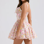 Pink floral print mini dress with fitted bodice, full skirt, and adjustable straps shown from side view — House of CB | Endless UAE