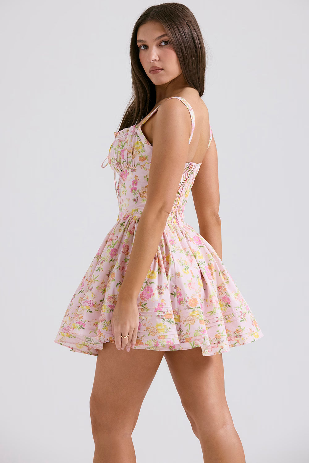 Pink floral print mini dress with fitted bodice, full skirt, and adjustable straps shown from side view — House of CB | Endless UAE