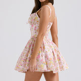 Pink floral print mini dress with fitted bodice, full skirt, and adjustable straps shown from side view — House of CB | Endless UAE