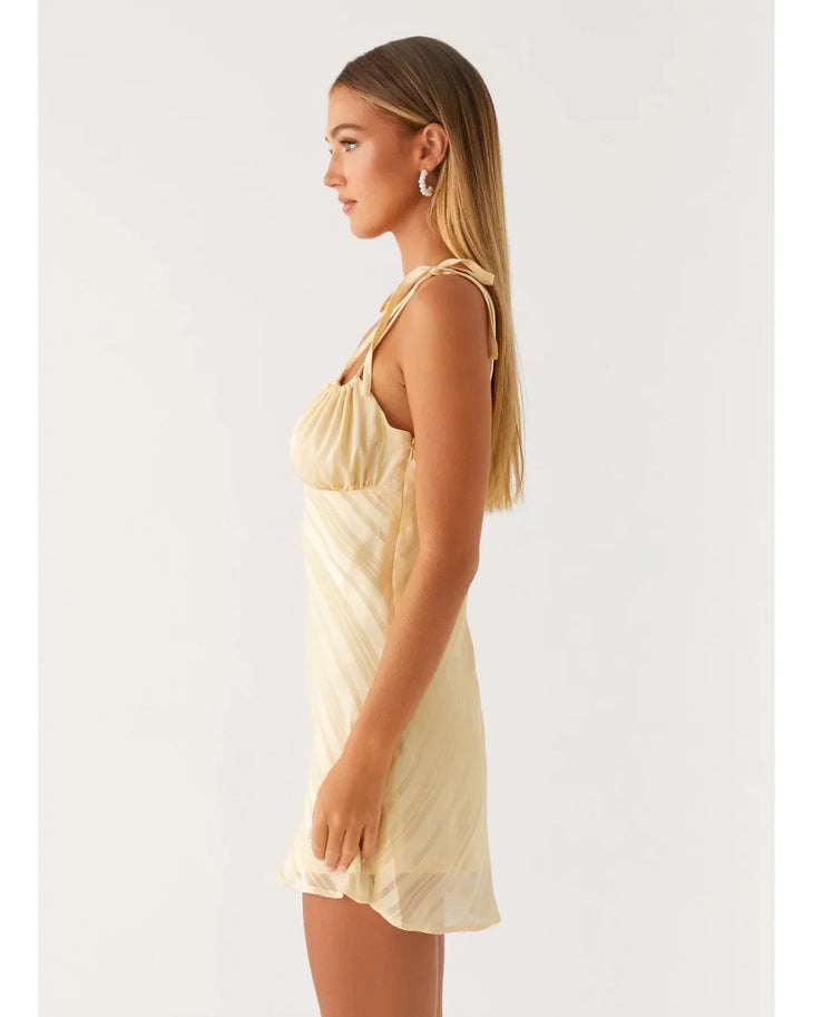 Cream tie-shoulder mini dress with wrap front and diagonal pleats — Peppermayo | Endless UAE