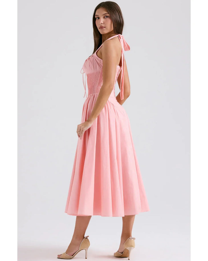 Woman wearing rose pink cotton halter midi sundress with ruched neckline and full skirt — House of CB | Endless UAE