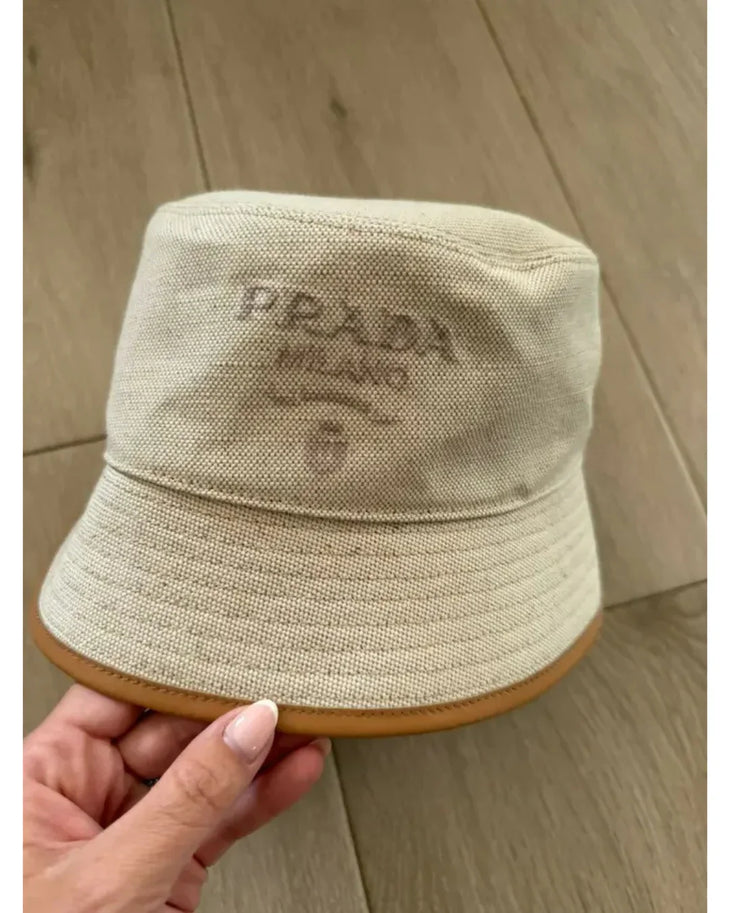 Cream linen blend bucket hat with tan leather trim and Prada logo — Prada | Endless UAE