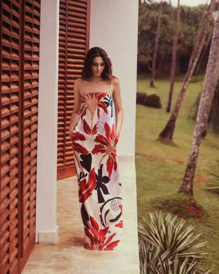 Woman wearing red and white floral maxi dress standing in modern corridor — Second Summer | Endless UAE