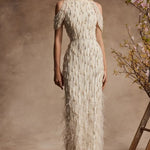 Ivory floor-length gown with beaded embellishments, draped sleeves, and feather trim hem — Pamella Roland | Endless UAE