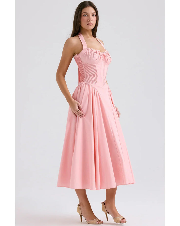 Woman wearing rose pink cotton halter midi sundress with ruched neckline and full skirt — House of CB | Endless UAE
