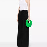 Bright green leather hobo bag held by model in white ribbed tank and black wide-leg pants — Bottega Veneta | Endless UAE