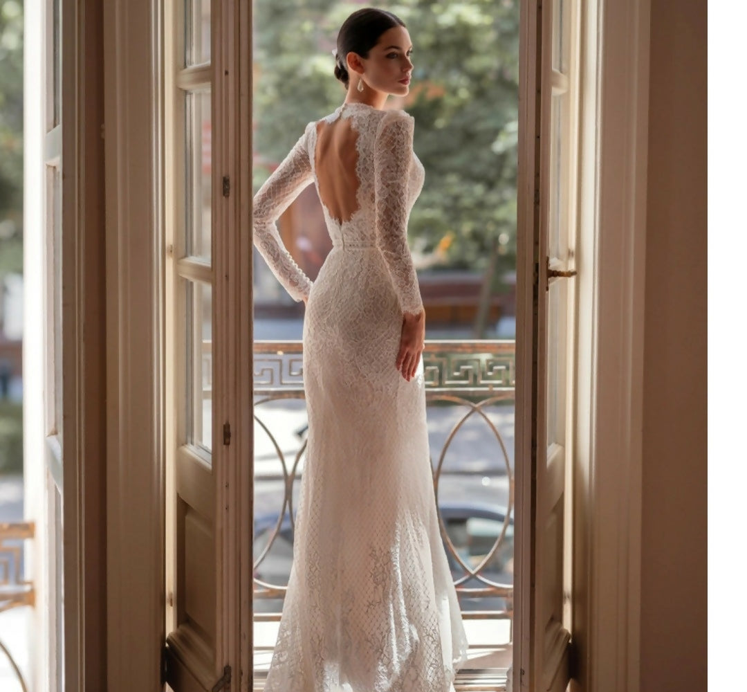 Elegant white lace wedding dress with long sleeves and flowing tulle train — Tatiana Kaplun | Endless UAE