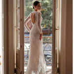 Elegant white lace wedding dress with long sleeves and flowing tulle train — Tatiana Kaplun | Endless UAE