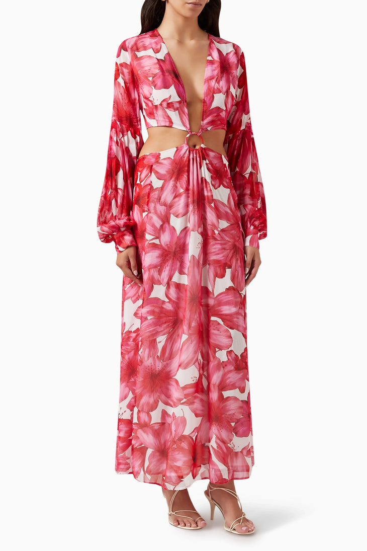 Woman wearing red floral cut-out maxi dress with long sleeves and gold sandals — Alexandra Miro | Endless UAE