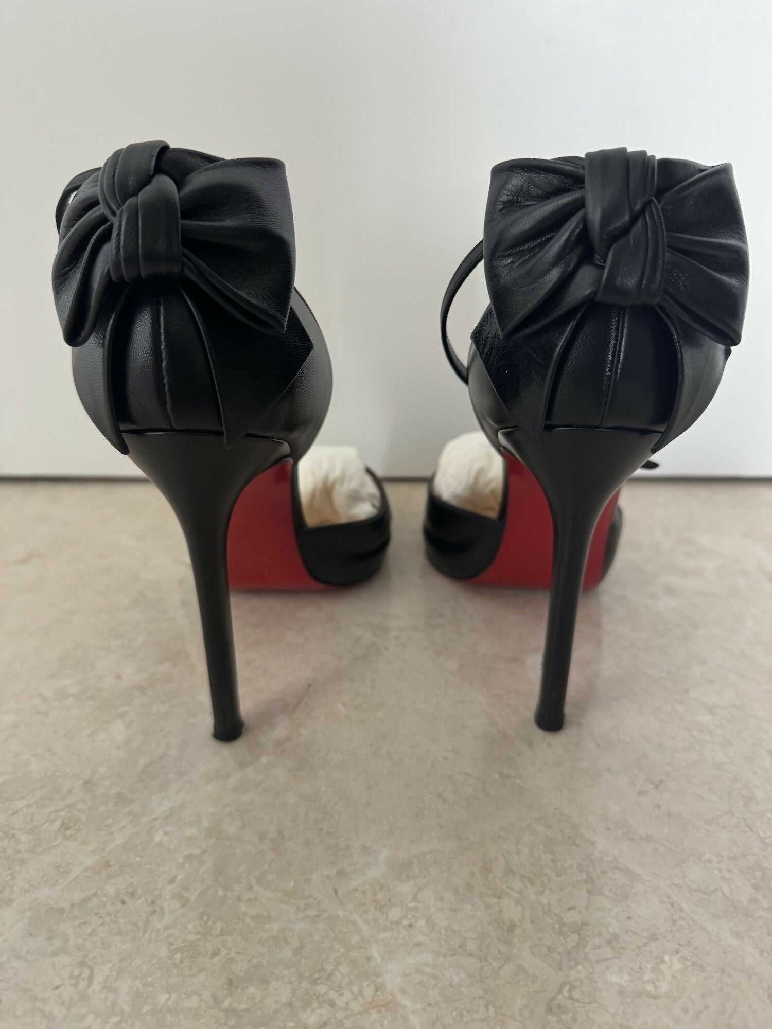 Black leather peep-toe platform pumps with bow detail and lace-up ankle straps — Christian Louboutin | Endless UAE