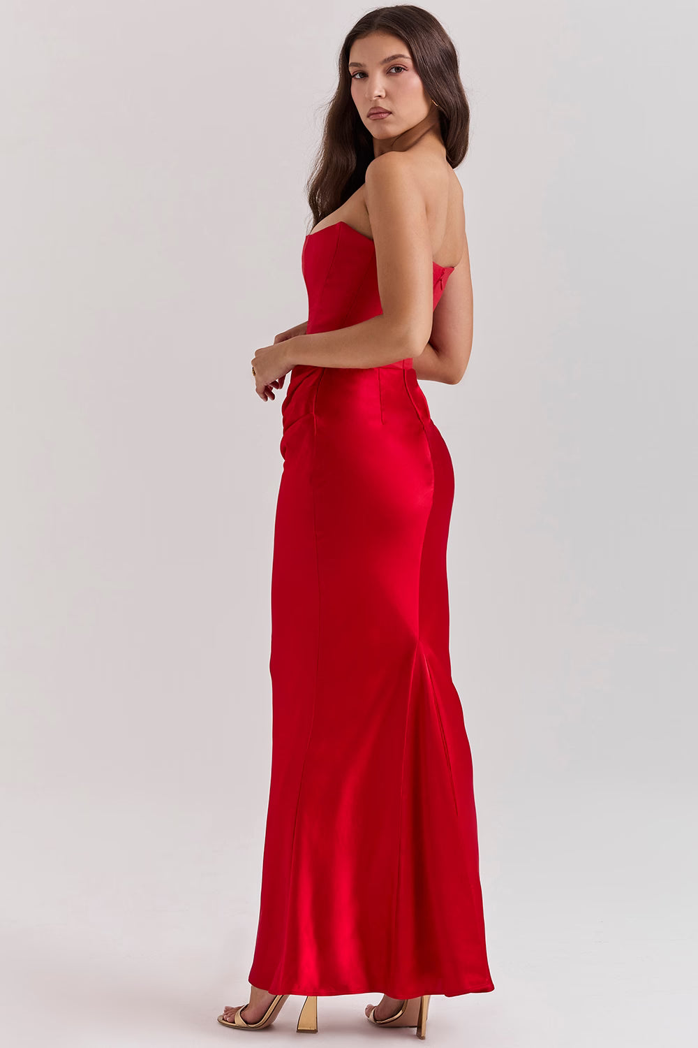Elegant red strapless corset maxi dress with fitted bodice and flowing skirt, shown from side angle — House of CB | Endless UAE