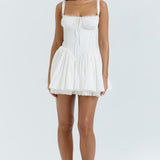 White corset mini dress with ruched bodice, tie front detail, smocked waist and flared skirt — House of CB | Endless UAE
