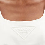White cotton-drill mini dress with embossed triangular logo detail at chest — Prada | Endless UAE