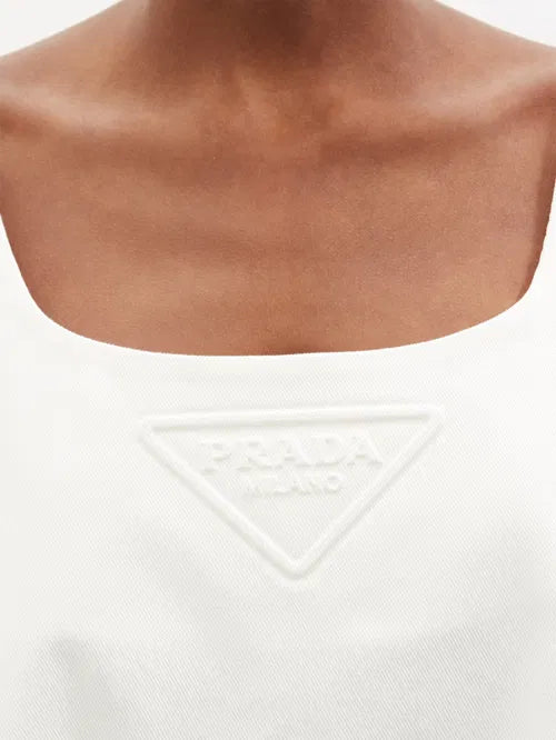 White cotton-drill mini dress with embossed triangular logo detail at chest — Prada | Endless UAE