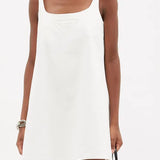 White cotton-drill mini dress with embossed triangle logo and square neckline on model — Prada | Endless UAE