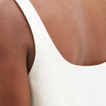 White cotton-drill mini dress with triangle embossed detail and sleeveless design — Prada | Endless UAE