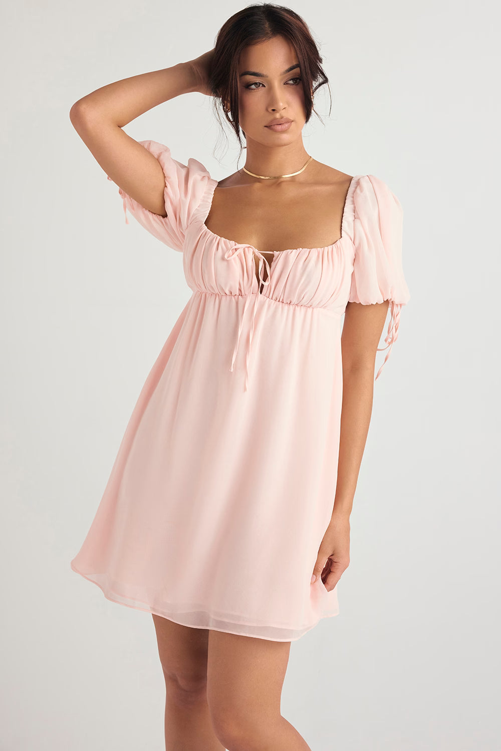 Soft pink babydoll mini dress with puff sleeves, empire waist, and tie-front detail — House of CB | Endless UAE