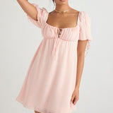 Soft pink babydoll mini dress with puff sleeves, empire waist, and tie-front detail — House of CB | Endless UAE