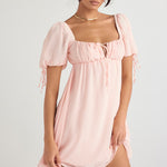 Soft pink mini dress with puff sleeves, square neckline and tie-front detail on model — House of CB | Endless UAE