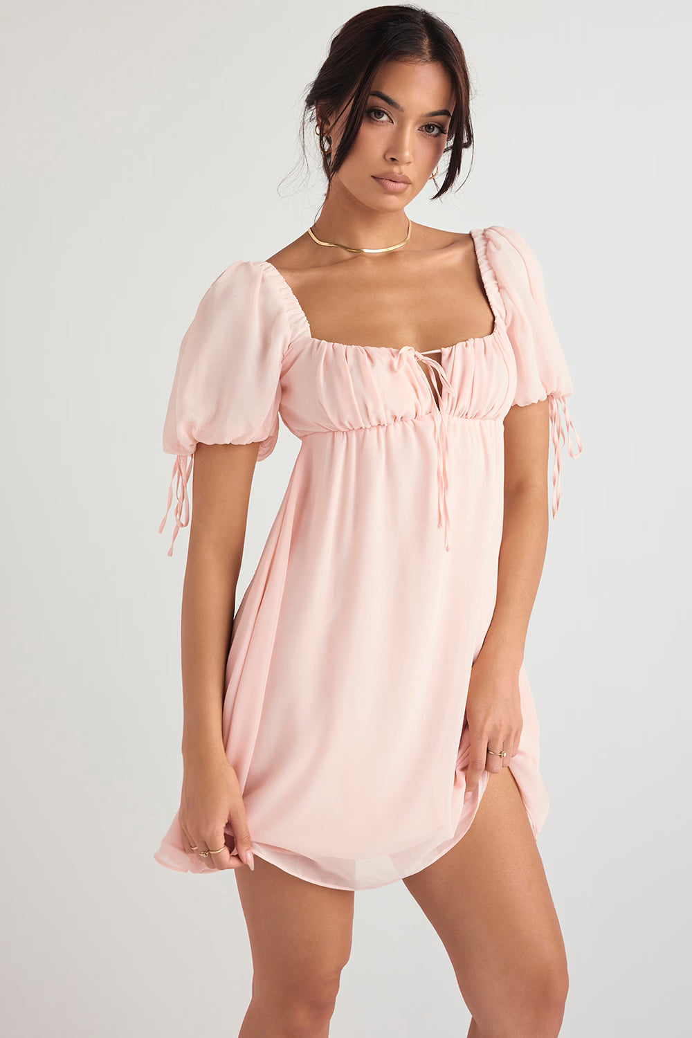 Soft pink mini dress with puff sleeves, square neckline and tie-front detail on model — House of CB | Endless UAE
