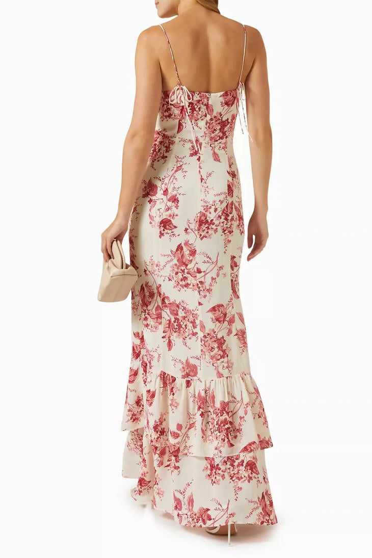 Woman wearing a cream and pink floral maxi dress with spaghetti straps and tiered ruffled hem — Reformation | Endless UAE