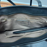 Black leather tote bag with dual handles and Coach branding — Coach | Endless UAE