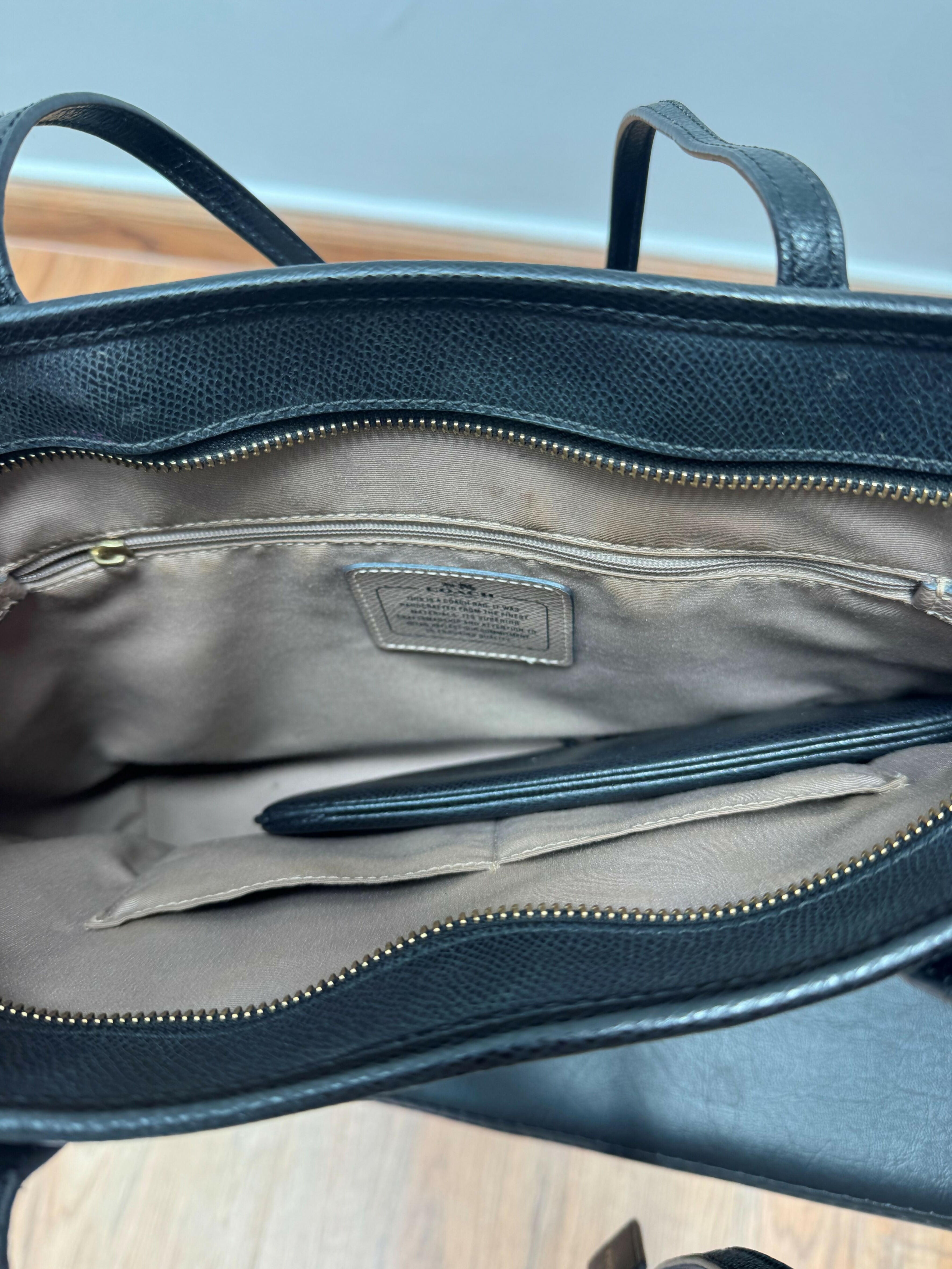 Black leather tote bag with dual handles and Coach branding — Coach | Endless UAE