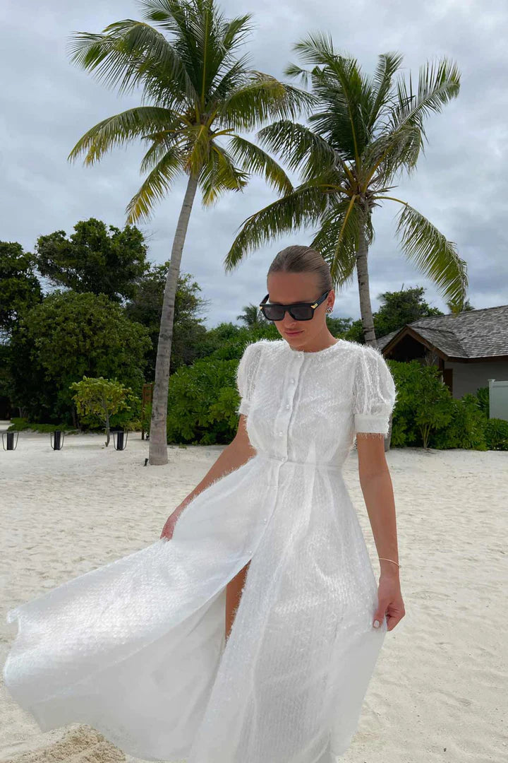 White sequin midi dress with puff sleeves on beach with palm trees — Post Meridiem | Endless UAE