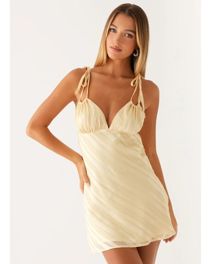 Cream tie-shoulder mini dress with wrap front and diagonal pleats — Peppermayo | Endless UAE