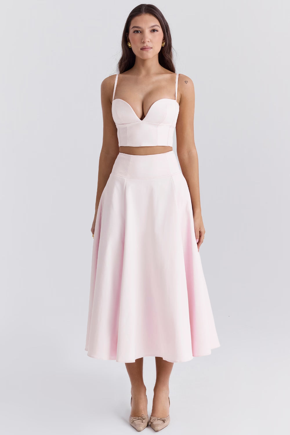 Elegant pale pink two-piece set with structured bustier crop top and flowing midi skirt — House of CB | Endless UAE