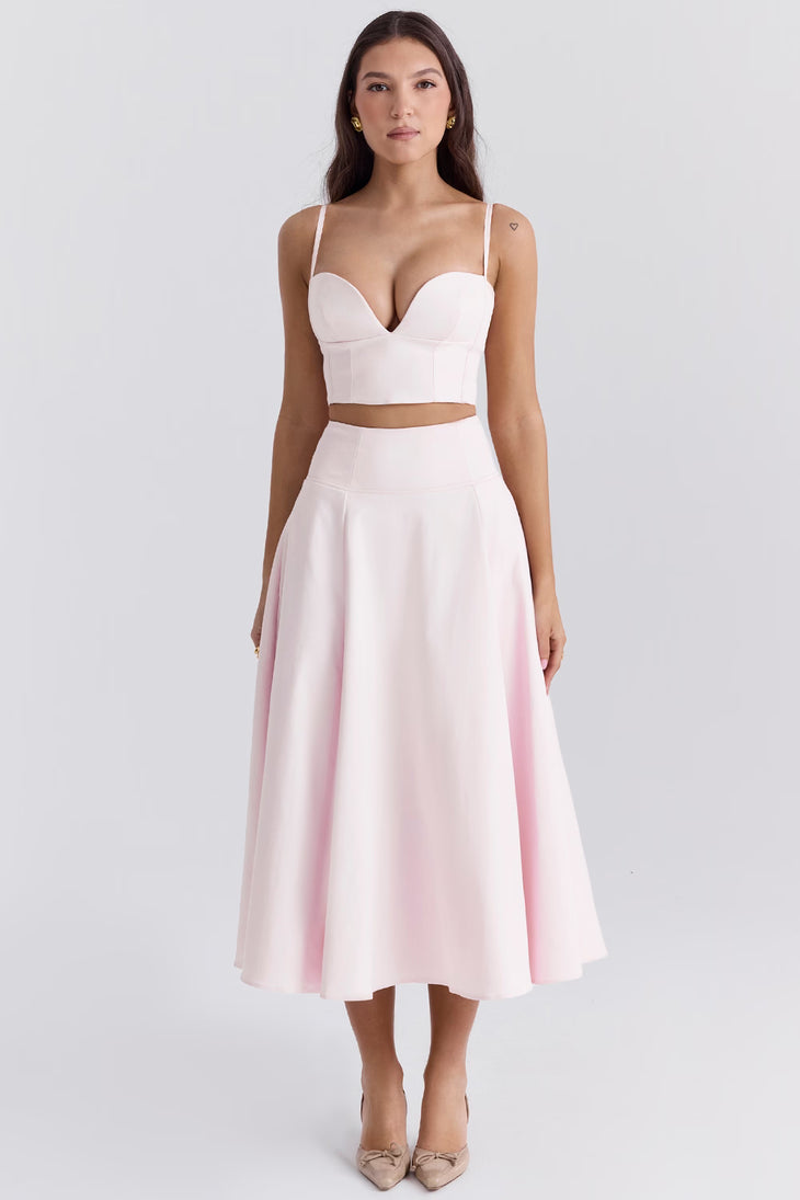 Elegant pale pink two-piece set with structured bustier crop top and flowing midi skirt — House of CB | Endless UAE
