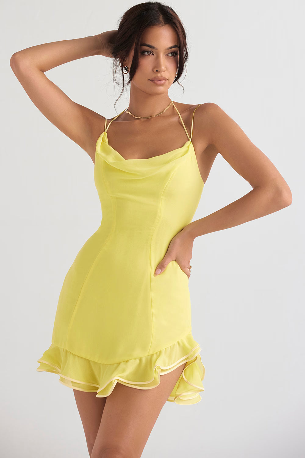 Model wearing buttercup yellow mini dress with cowl neckline, thin straps and layered ruffle hem — House of CB | Endless UAE