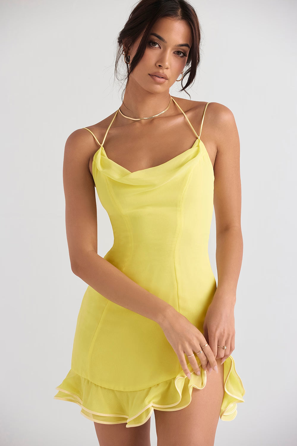 Bright yellow mini dress with cowl neckline, thin straps, and tiered ruffle hem modeled on woman — House of CB | Endless UAE