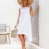 Woman in white sleeveless linen dress with sun hat and woven bag in minimal setting — Magic Linen | Endless UAE